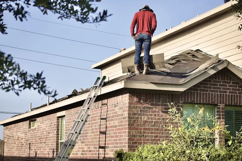 Professional roofer working on a residential roof in Fergus Falls